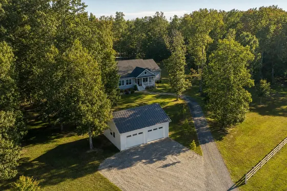 Garage and home on a wooded Southern Maryland property