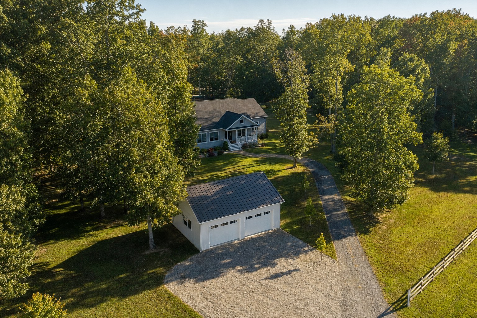 Detached garage and home on a wooded Southern Maryland residential property